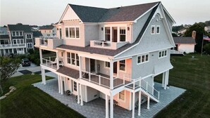 A two-story house with a balcony, a covered front porch, and a driveway.