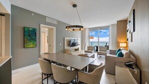 A modern hotel room with a dining area, a living area with a view, and a balcony. - Ocean front 2 bed 15th floor Hollywood Miami (Hollywood)