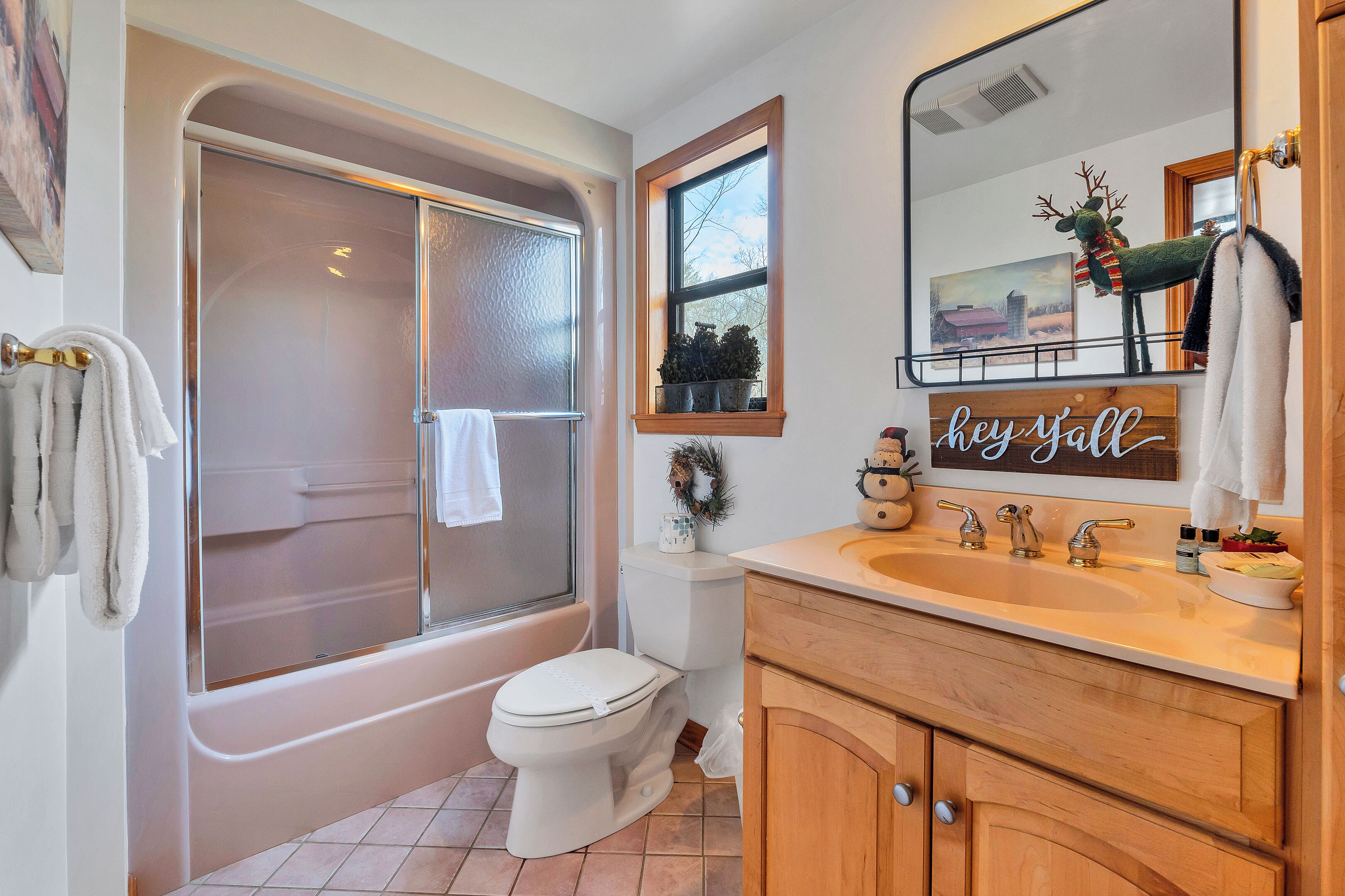 A bathroom with a bathtub, toilet, and sink.