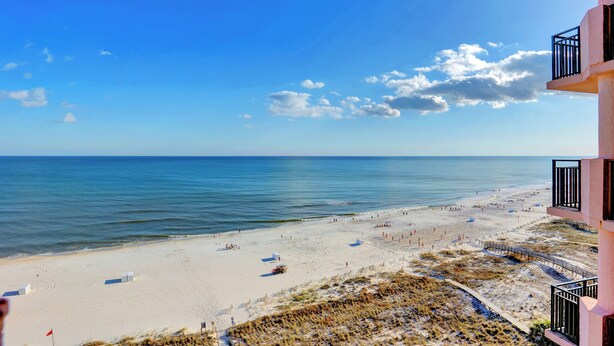 A beach view from a balcony with a clear sky and ocean. - SeaChase 1002W BY Liquid Life (Orange Beach)