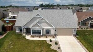 A single-story house with a garage, a covered front porch, and a well-maintained lawn. - Beautiful New House in great Northern neighborhood- close to all!  (Fort Wayne)