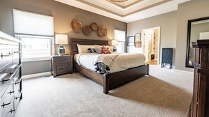 A bedroom with a large bed, a dresser, a nightstand, and a ceiling light. - Beautiful New House in great Northern neighborhood- close to all!  (Fort Wayne)