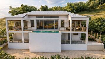 A modern multi-level house with a pool, outdoor seating, and a staircase.