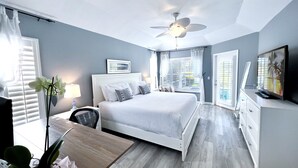 A modern bedroom with a large bed, a ceiling fan, a desk, and a TV. - Gorgeous Naples home with Saltwater pool in a gated community  (Naples)