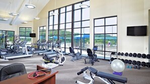 A gym with cardio machines, weightlifting equipment, and a view of the outdoors. - Perfect Getaway - Cozy Cottage in The Galena Territory (Galena)
