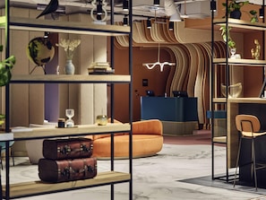 A modern interior with a reception desk, seating area, and decorative elements.