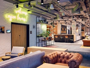 Een modern interieur met een neonbord, zithoeken en een bar.