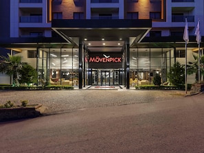 A hotel entrance with a glass facade, a sign reading 'MÖVENPICK,' and a well-lit lobby area. - Mövenpick Hotel Trabzon (Trabzon)