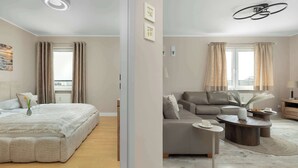 A modern hotel room with a large bed, a sofa, a coffee table, and a dining table. - Apartment with Sea View | 200 m to the Beach, Balcony (Kolobrzeg)