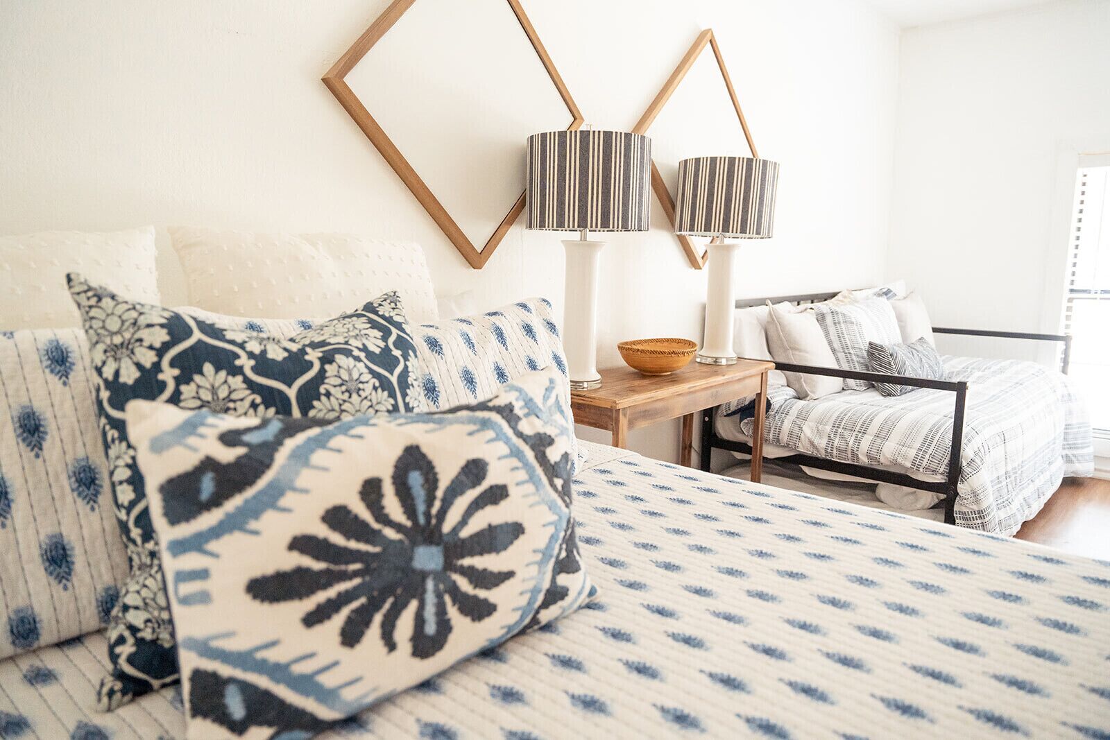 A bedroom with a bed, two bedside tables, a chair, and a lamp.