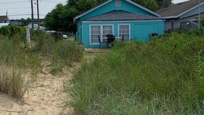 A small, single-story house with a blue exterior and a front porch. - Rustic Ocean View Beach House - BEST Location in Ocean View! 2 bed/1 bath House (Norfolk)