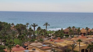 A coastal resort with multiple buildings, palm trees, and a view of the ocean. - Stunning Ocean View at Bella Sirena.  Most tropical resort on Sandy Beach. (Puerto Peñasco)