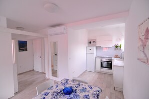 Cozy living area with dining table and modern kitchen amenities.