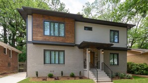 A modern two-story house with a brick facade, large windows, and a well-maintained lawn. - " Top Notch House In Perfect Location" (Atlanta)