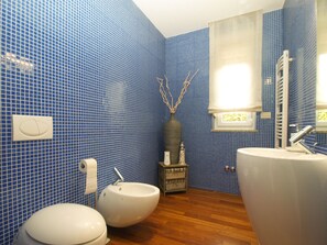 A bathroom with blue tiled walls, a wooden floor, a bidet, a toilet, and a large sink. - Villa 2103/39323 (Istria - Pula), 2500m from the beach (Pula)