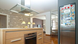 A modern kitchen with a built-in oven, a stainless steel refrigerator, and a stone backsplash. - Villa 2103/39323 (Istria - Pula), 2500m from the beach (Pula)