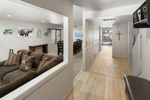A modern living room with a sofa, a fireplace, and wall art.