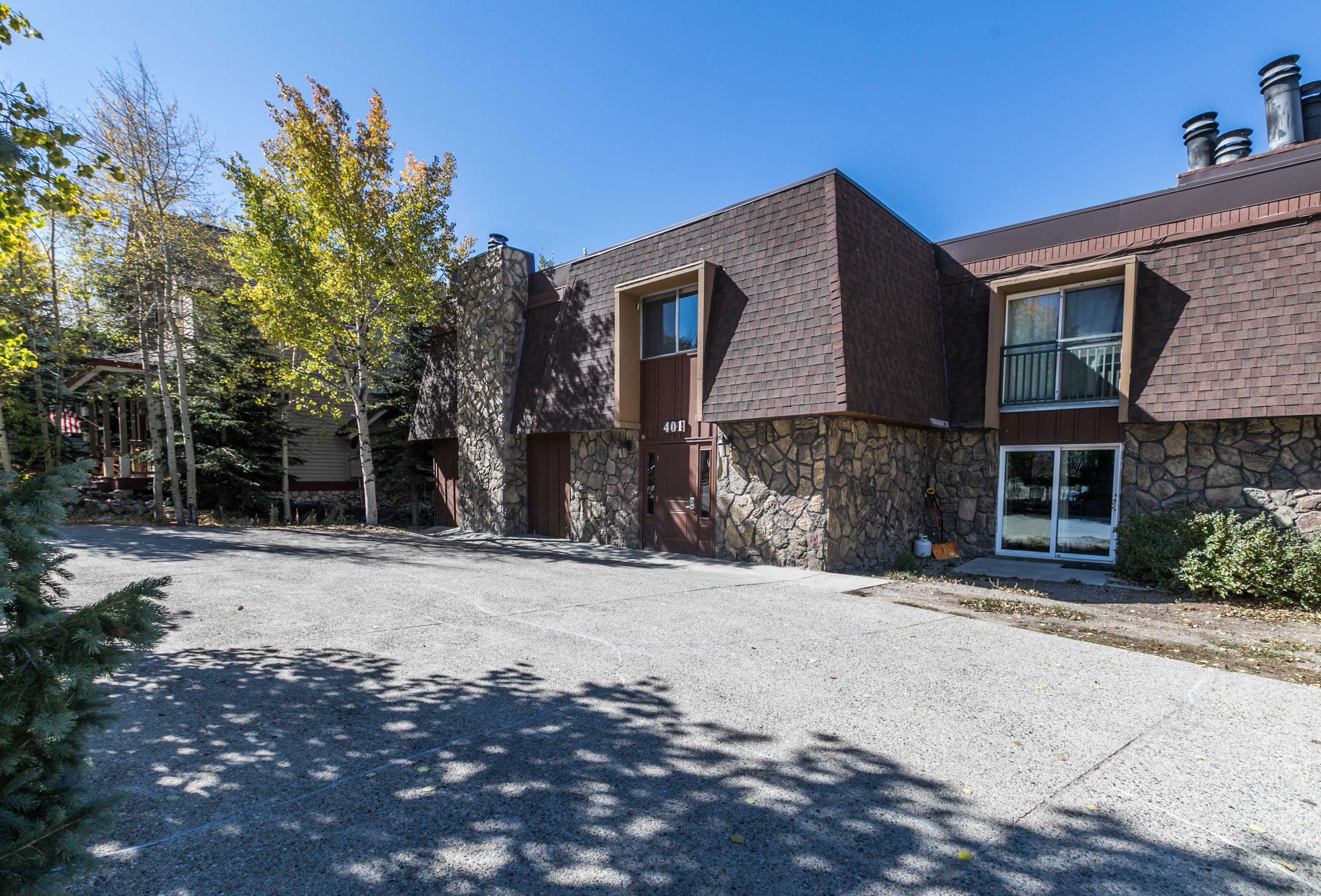 A two-story building with a stone facade and a brick roof.