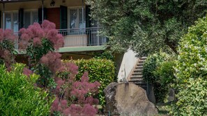A stone staircase leading up to a building with a balcony.