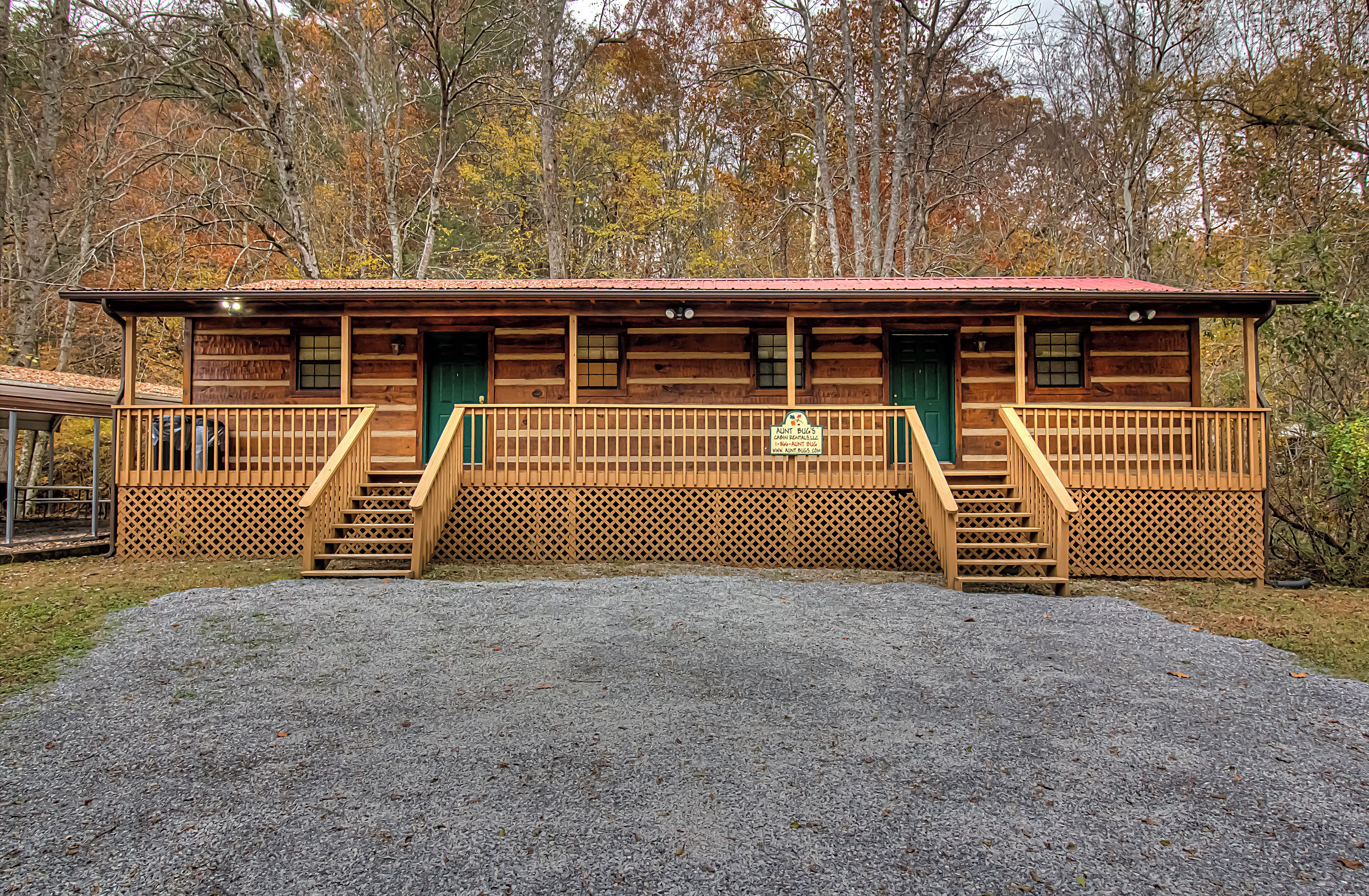 A wooden cabin with a porch and stairs leading to the entrance.