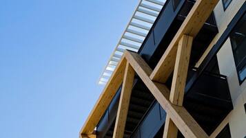 A multi-story building with a distinctive wooden framework and balconies.