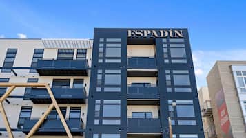 A multi-story building with the name 'ESPADIN' prominently displayed.