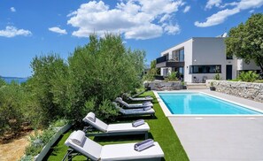 A heated pool, pool loungers