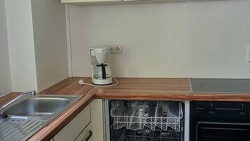 Fridge, stovetop, dishwasher, coffee/tea maker