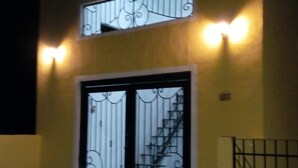 A building with a double door and a staircase leading to an upper level. - Loft " El Mestizo" (Celestún)