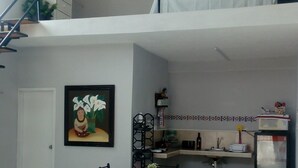 A multi-level living space with a dining area, kitchen, and staircase. - Loft " El Mestizo" (Celestún)