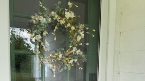 A green glass door with a brass handle and a keyhole.
