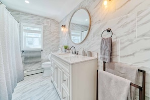 Bathtub, hair dryer, towels, soap