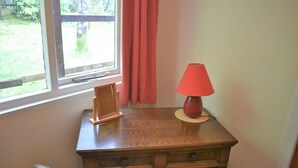 A wooden dresser with a lamp and a picture frame on top. - Camus Slatach - sleeps 4 guests  in 2 bedrooms (Glenfinnan)