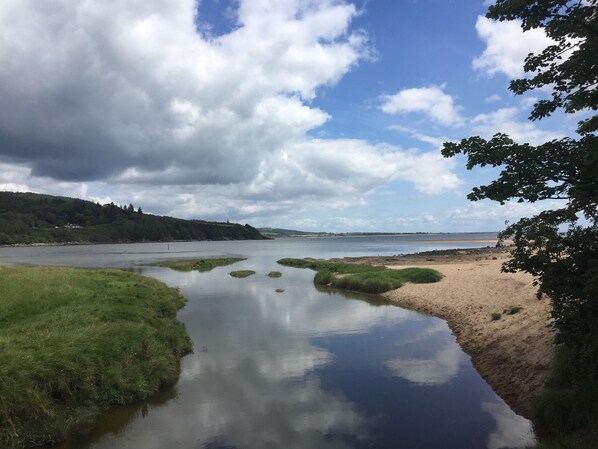 A river meandering through a natural landscape with a sandy beach and grassy areas. - Birchlea -  a lodge that sleeps 6 guests  in 3 bedrooms (Kippford, Dalbeattie)