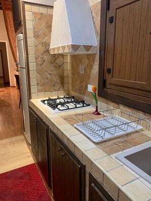 Fridge, stovetop, coffee/tea maker, cookware/dishes/utensils