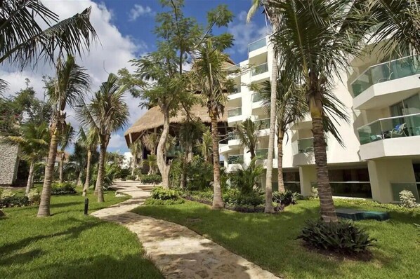 Escape to a serene tropical haven surrounded by lush greenery and palm trees.