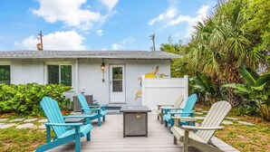 A deck with outdoor seating and a house in the background. - 2-Min Walk to Beach, 3 Cars, 3BR Family Escape walkable to Boardwalk (Daytona Beach)