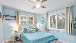 A bedroom with a bed, a nightstand, a ceiling fan, and a window with curtains. - 2-Min Walk to Beach, 3 Cars, 3BR Family Escape walkable to Boardwalk (Daytona Beach)
