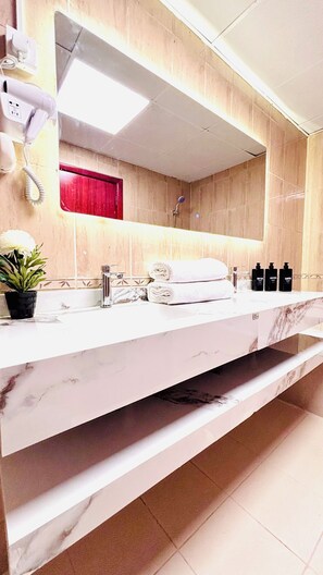 Bathtub, hair dryer, towels, soap - Canal View One BHK  Apartment With Parking (ajman)