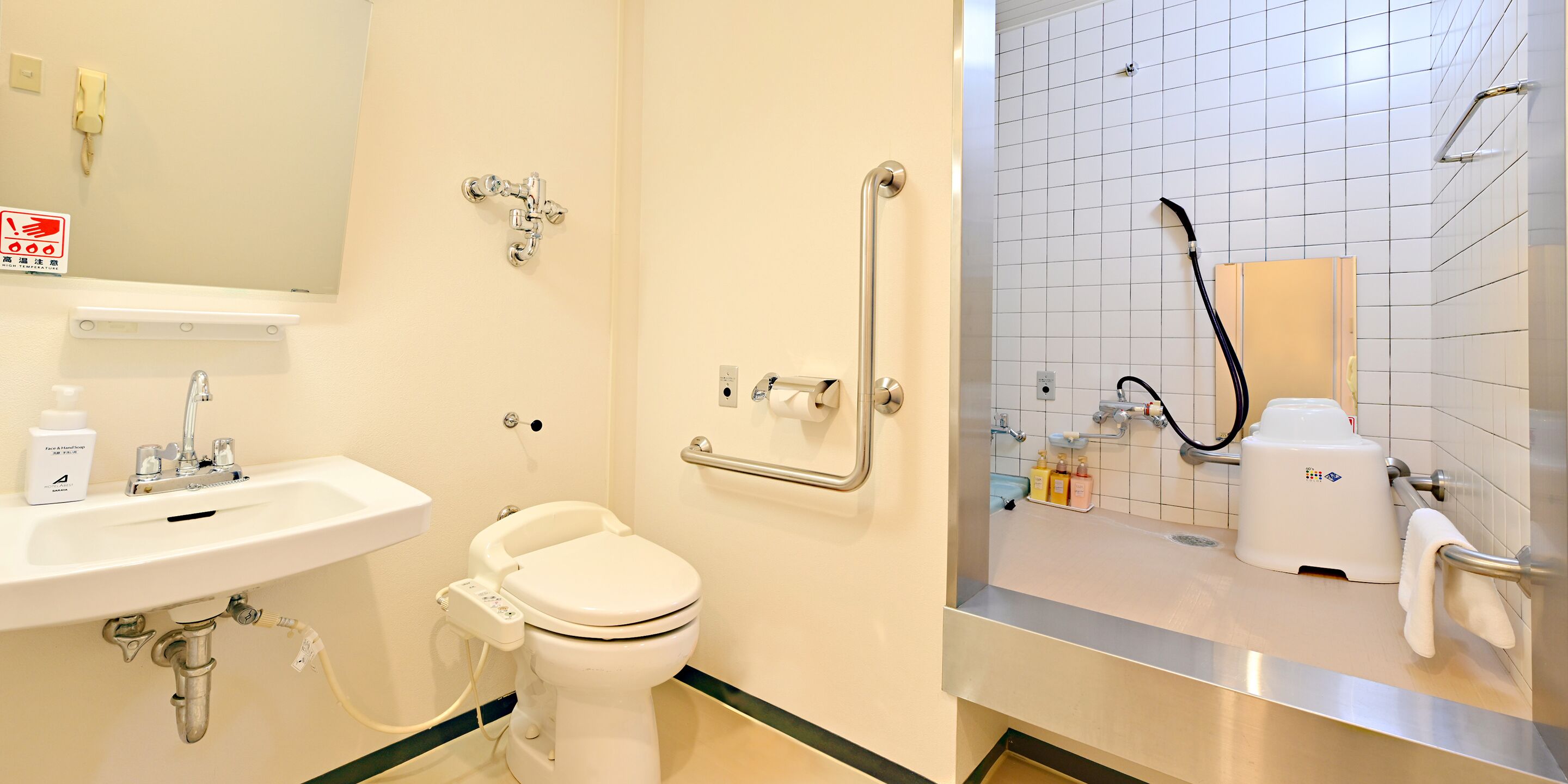 A modern bathroom with a sink, toilet, and shower area.