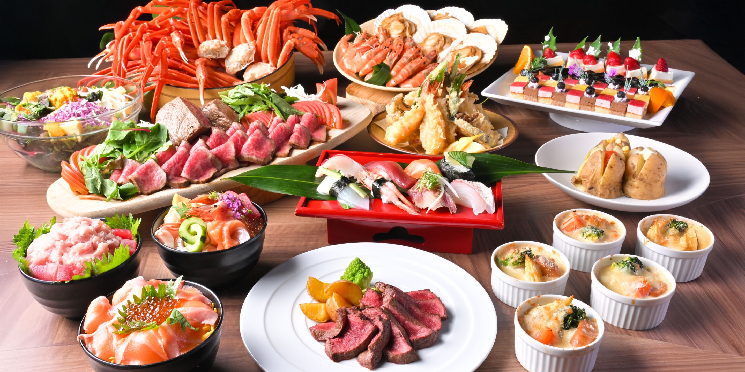A variety of seafood dishes, including sushi and crab legs, arranged on a wooden table.