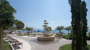 A park with a central fountain, benches, and a paved walkway. - Beautiful, Modern Apartment Near the Sea, Croatia (Kastela)