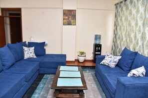 Deluxe Room | Living area | 56-inch Smart TV with digital channels, TV