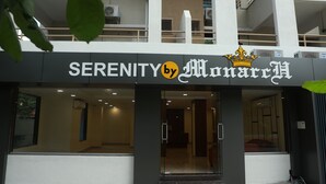 A building with a sign that reads "SERENITY by Monarchy".
