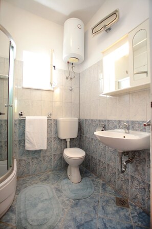 Appartement, plusieurs lits | Salle de bain | Douche, articles de toilette gratuits, sèche-cheveux