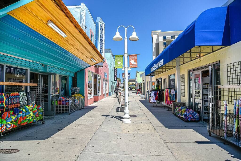 A colorful street with shops and a clear sky.
