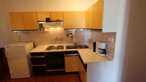 Fridge, stovetop, coffee/tea maker, cookware/dishes/utensils