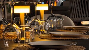 A dining table set with wine glasses, plates, and a candle. - Carpe Diem Boutique Hotel - Adults Only (Manavgat)