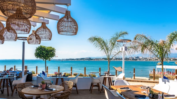 An outdoor dining area with wicker chairs and tables, overlooking a coastal view. - Carpe Diem Boutique Hotel - Adults Only (Manavgat)