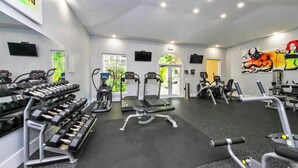 A gym with treadmills, elliptical machines, and weight machines. - LUXURY THE YATCH 301- FREE PARKING AND WIFI (Aventura)